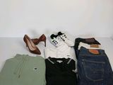 un tas de vêtements et une paire de chaussures posés sur une table