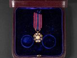 an image of a medal in a case with a ribbon around it