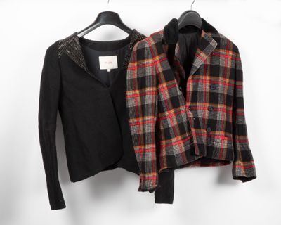 two jackets are hanging on a clothes rack in front of a white wall