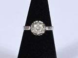 a close up of a diamond ring on a black ring stand