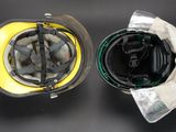 a yellow helmet and a black helmet on a black table