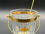 a close up of a glass ice bucket with a straw sticking out of it