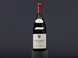a bottle of wine on a table with a black background