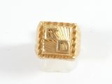 an image of a gold ring on a white surface