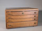 a small wooden chest of drawers with four drawers