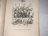 an open book with a picture of a group of animals