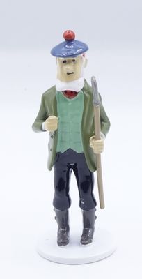 a figurine of a man with a hat and a cane