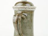 a close up of a coffee pot on a white surface