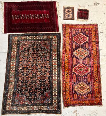 three oriental rugs are laid out on a white surface