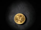 a gold coin on a black background