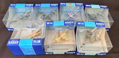 Six boîtes contenant un assortiment d'avions miniatures sont posées sur une table.
