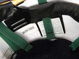 a black purse with a green strap and a book