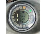 a close up of a digital clock on a motorcycle