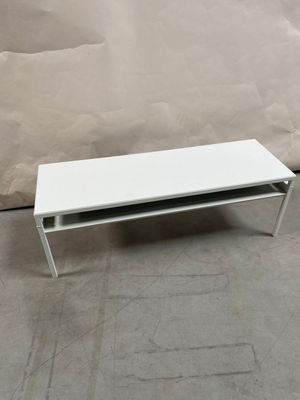 an image of a white coffee table on a concrete floor