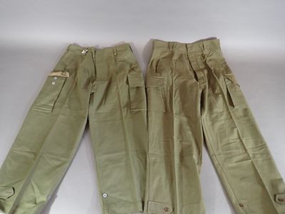 two pairs of khaki pants are lined up on a white surface