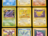 several pokemon cards are displayed on a black surface