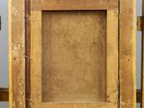 an old picture frame sitting on top of a wooden easel