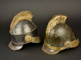 pair of antique roman helmet on black background with gold accents