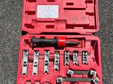 a red case with tools in it sitting on the ground