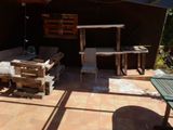 a patio area with a table, chairs, and a grill