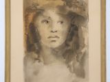 portrait of a woman in a hat by a wall