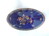 a blue plate with a gold design on it