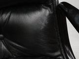 a close up of a black leather chair with a black seat
