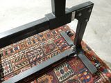 a close up of a metal frame on a rug