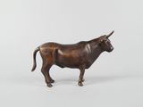 bronze figurine of a bull on a white background