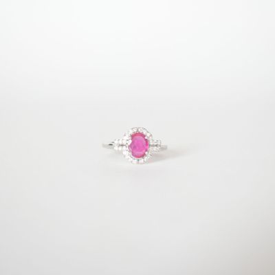 a pink sapphire and diamond ring on a white background