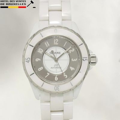 a picture of a white ceramic watch with a black face