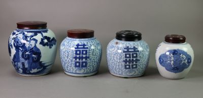 four blue and white vases are lined up against a gray background