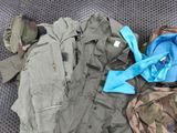 many different types of military clothing laid out on the floor