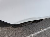 a close up of a car ' s bumper with a dent on it