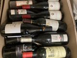 many bottles of wine in a box on the counter