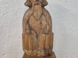 an old wooden statue of a man with a beard and a beard