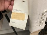 someone is holding a tag that says reference on a suit