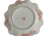 a white plate with a red design on it
