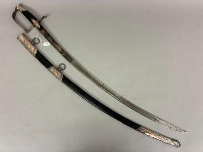 two swords with black handles and a silver handle on a white surface