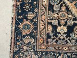 an old rug is laying on the floor next to a cat