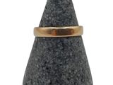 an image of a gold ring on a black stone
