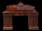 an antique desk with a carved top and a wooden base
