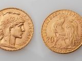 two gold sovereigns, one of which is a woman and one of which is a man