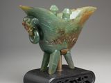 an image of a green vase with a bird on top of it