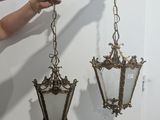 someone is holding a pair of hanging light fixtures in their hand