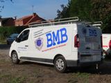 a white van that is parked on the side of the road