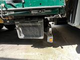 a green truck that is parked on the side of the road