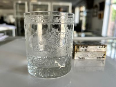 a glass of water sitting on a table next to a box