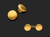 a close up of a pair of gold cufflinks and a pair of earrings