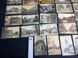 a lot of old photos on display on the table